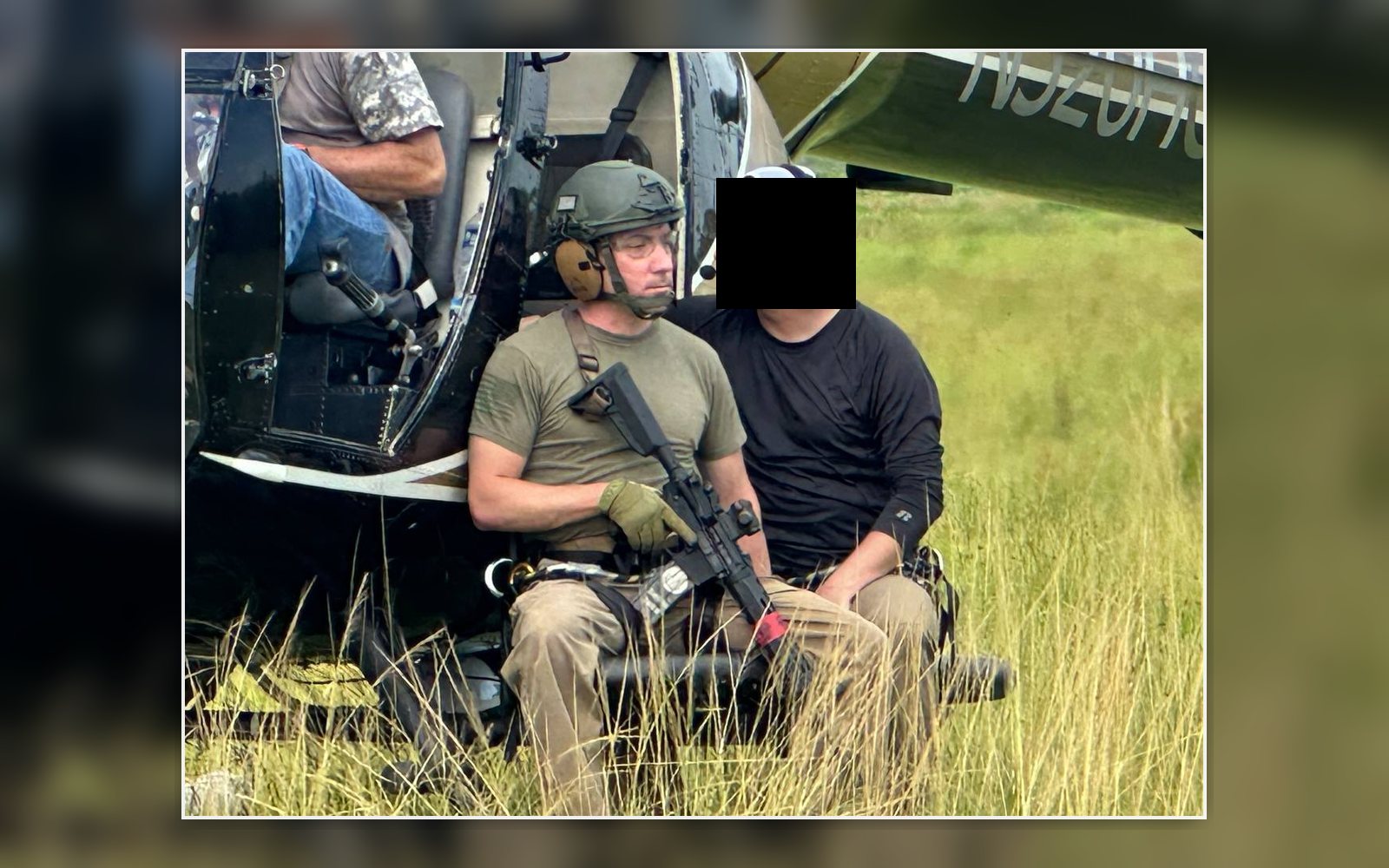 Christopher Key seated beside helicopter during executive protection training